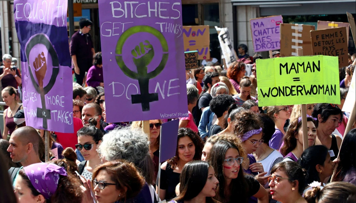 Sea of purple: Swiss women strike for equal pay, raise feminist slogans