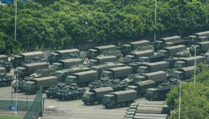 Chinese military personnel parade near Hong Kong border