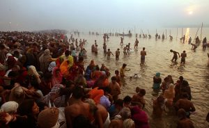 ALLAHABAD, INDIA - JANUARY 23: Hindu pilgrims gather to bathe at sunrise at the ritual bathing site at Sangam, the confluence of the Ganges, Yamuna and mythical Saraswati rivers during the Ardh Kumbh Mela festival (Half Pitcher festival) January 23, 2007 in Allahabad, India. Today is one of the major bathing days of the festival celebrating the first day of spring in North India. Tens of millions of Hindu pilgrims have already attended the 45 day festival in northern India which is the largest religious gathering in the world. The festival commemorates the mythical conflict between gods and demons over a pitcher filled with the 'nectar of immortality'. Devotees believe that taking a holy dip in the Ganges at this time washes away their sins and paves the path to salvation. (Photo by Mario Tama/Getty Images)